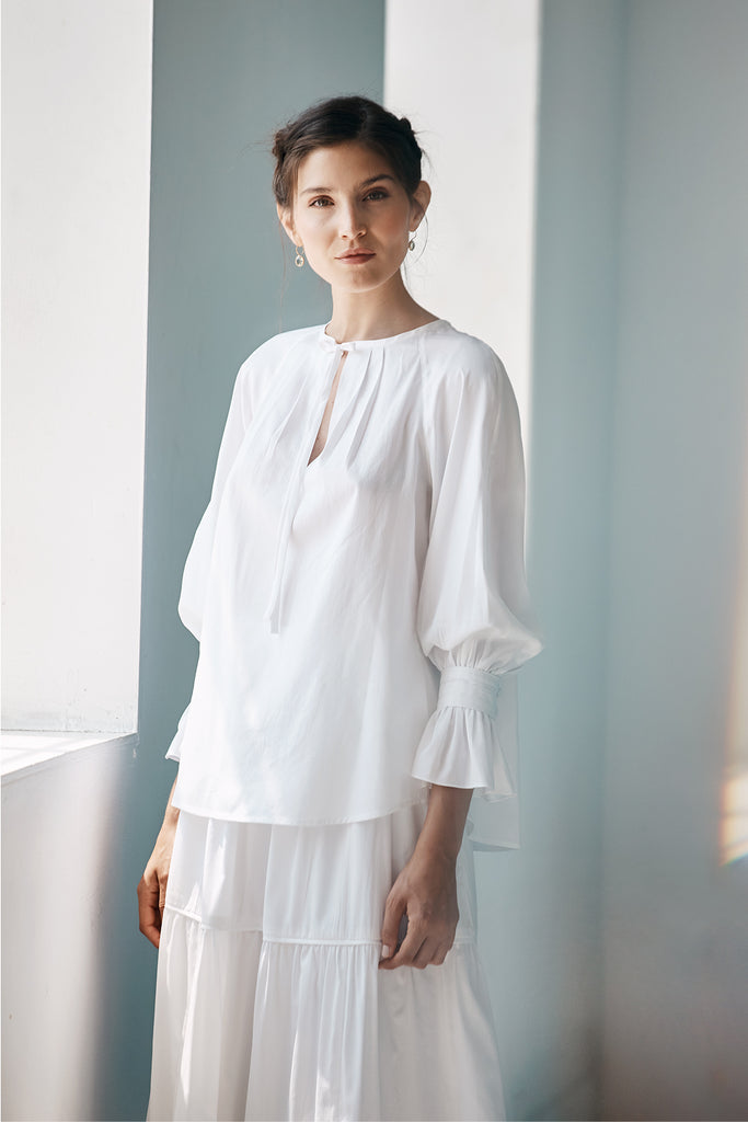 Model wearing the Lilli Blouse in white.