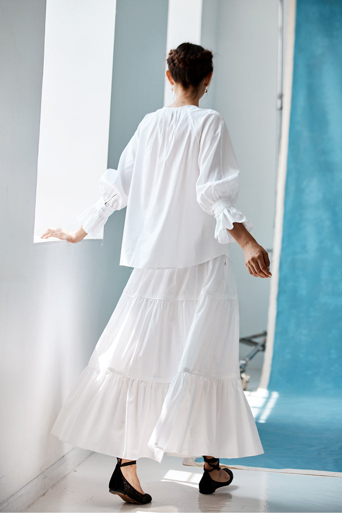 The back of a model wearing the Lilli Blouse in white.