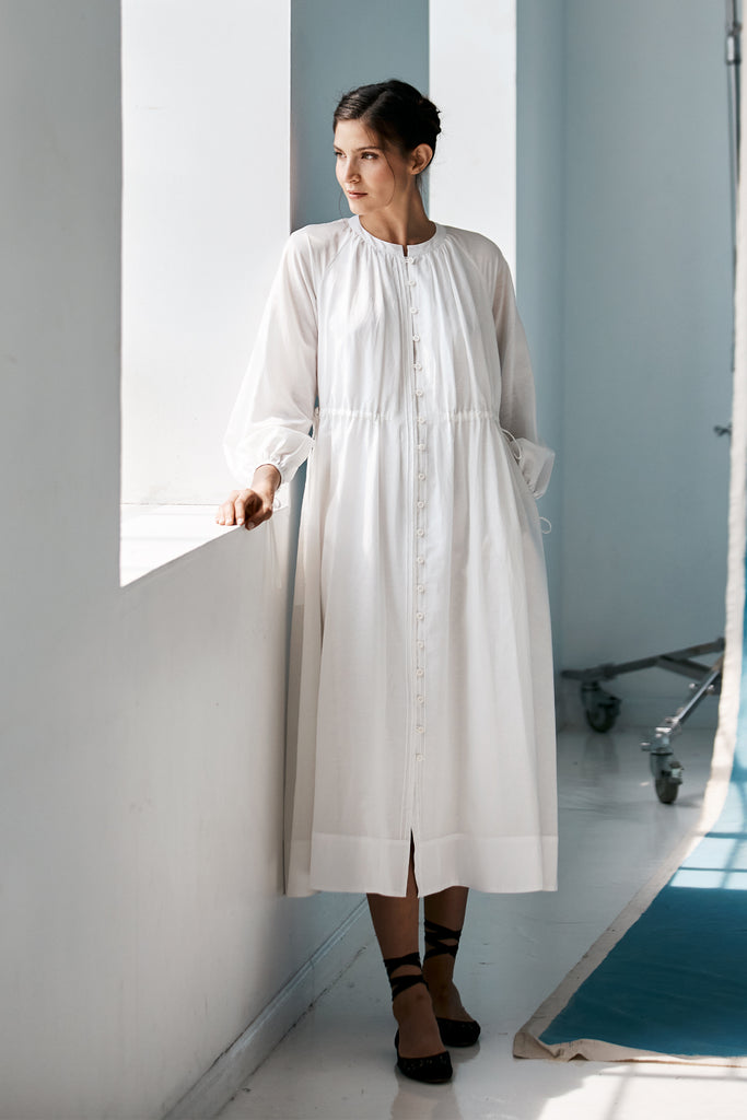 Model looking to the side wearing Mia Caftan Dress made with White Linen and Cotton