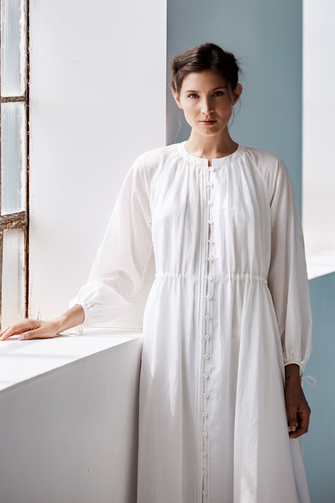 Model looking head on wearing Mia Caftan Dress made with White Linen and Cotton