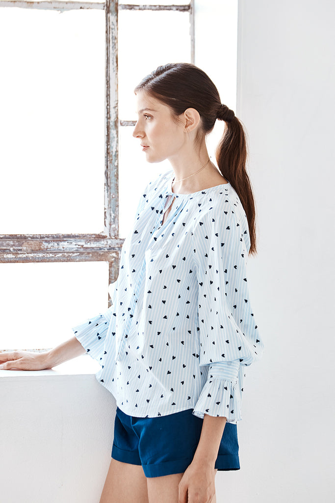 Model wearing the Danielle Fichera Lilli Blouse in Navy Heart and French Stripe colors.