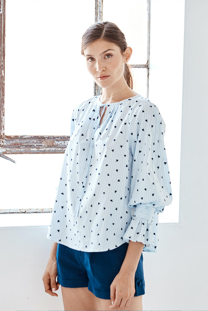 Model wearing the Danielle Fichera Lilli Blouse in Navy Heart and French Stripe colors.