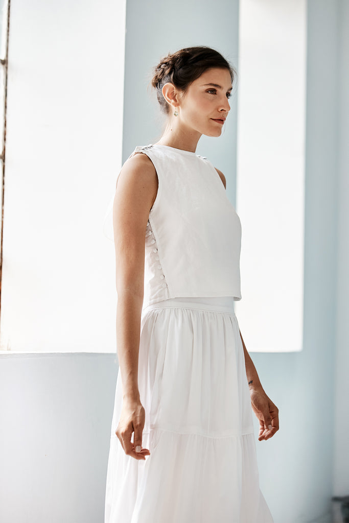 Model wearing Emma Gilet in white. 