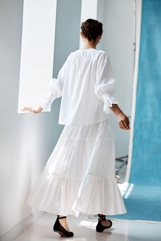 Model wearing the tiered Vivienne Skirt by Danielle Fichera in White. 